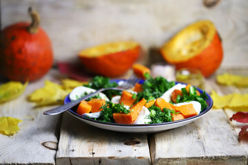 Autumn salad with pumpkin on a plate. Autumn food. Fall mood.