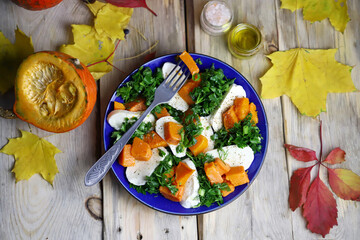 Autumn salad with pumpkin on a plate. Autumn food. Fall mood.
