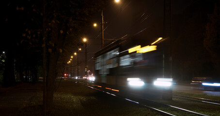 The tram rides by railway  in the night city