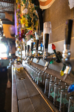 String Lights Hanging Over Beer Taps In Brewery