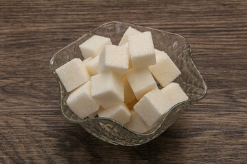 Refined white sugar cubs in the bowl