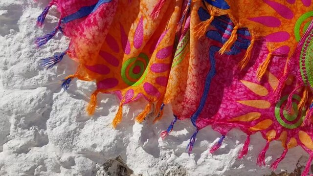 Close up of a scarf. Folds of silk fabric with tassels shaking in wind