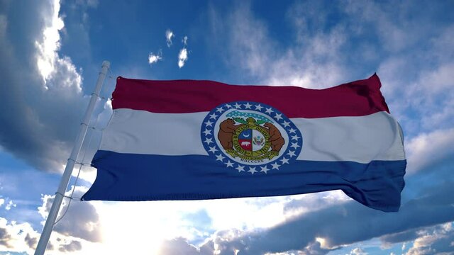 Missouri flag on a flagpole waving in the wind, blue sky background. 4K