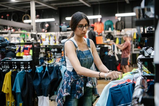 Woman shopping for clothing in sporting goods store
