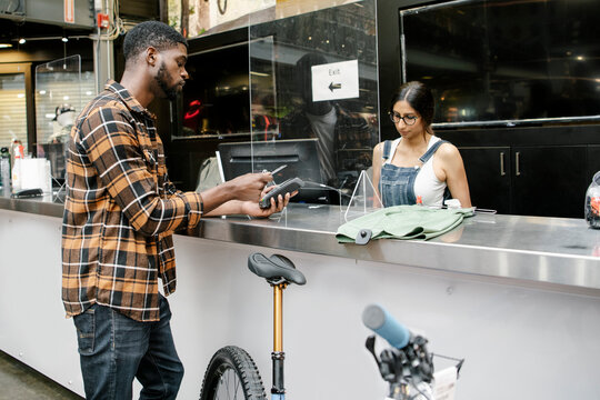Customer paying with credit card at bike shop counter