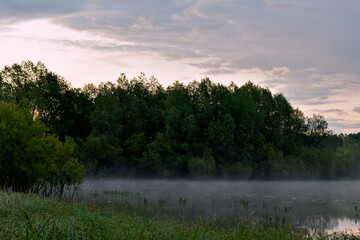 Obraz na płótnie Canvas colorful and misty dawn over a small river