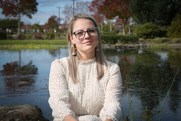Close up Portrait of Beautiful 30 Years Old Woman in Glasses wearing White Dress, Fall Background 