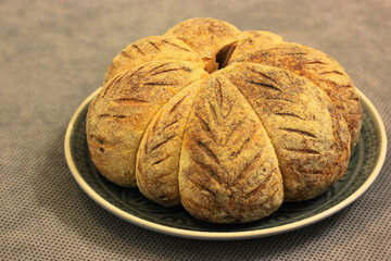 Homemade pastry, fresh pumpkin-shaped bread, background for Thanksgiving and Halloween.