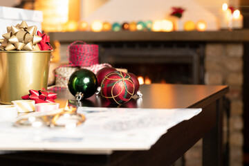 Gift workshop in a warm cozy room. Christmas decorations by fireplace.