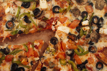 pizza with mushrooms, olive and other various products, close up