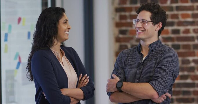 Portrait of man and woman smiling in office