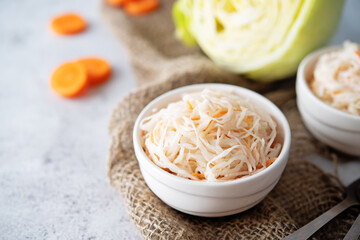 Fresh raw pickled cabbage with casrrot in a white bowl