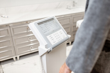 Man measuring body composition balance, holding handles of a medical scales during Inbody test