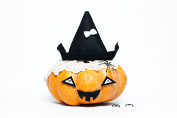 Studio portrait of happy halloween pumpkin of orange color, wearing black hat, isolated on white background.