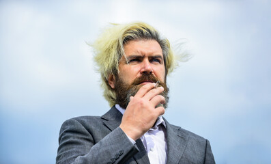 Breathe in and out. Smoking habit concept. Bearded hipster smoking outdoors. Smell of smoke....