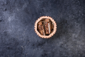 Obraz na płótnie Canvas New Year's set for mulled wine in a wood box. Fragrant spices, orange peel, cinnamon sticks, badyan.