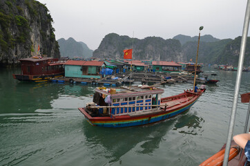 Small boat in the background of the fishing village. Vietnam. Halong.