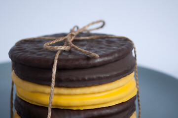 Stack of round cookies    covered dark and yellow chocolate, assorted