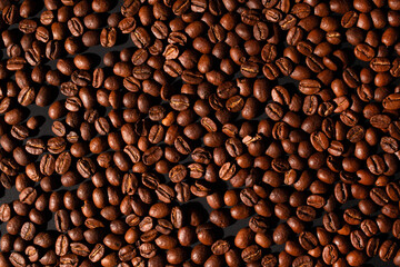 Fototapeta premium brown coffee beans, background texture, close-up. Top view.