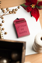 An ornament red mail box saying Letter to Santa on a notebook. Christmas tree decoration ideas.  - 388864267