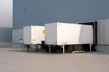 trailers at loading ramps of a warehouse