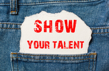 SHOW YOUR TALENT on white paper in the pocket of blue denim jeans