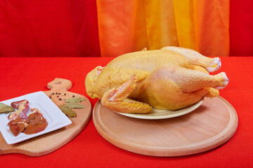 Raw chicken on black background. © Malsveta