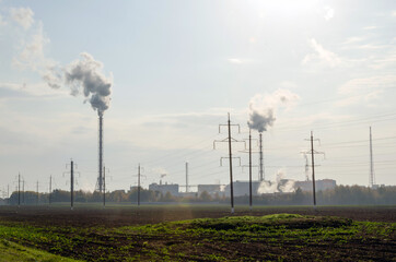 The plant emits smoke and smog from the pipes, and pollutants enter the atmosphere. Environmental disaster. Harmful emissions to the atmosphere.