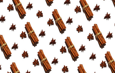 Cinnamon sticks and star anise on a white background. Christmas pattern, new year pattern