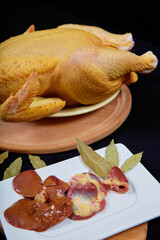 Raw chicken on black background.