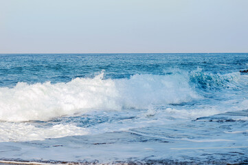 Naklejka na ściany i meble Pier and waves on the Mediterranean Sea in Turkey. Macrophoto. Turquoise background of water. Summer seascape. The concept and idea of travel. Copy space. Sea panorama.