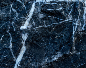 Textured background of black marble with white veins. Big plan. Top view. Copy Space.