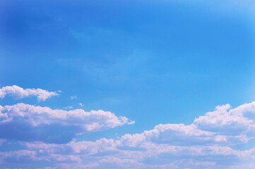 Beautiful alternating light and dark clouds in the blue sky in the summer morning as a background with the ability to insert text.