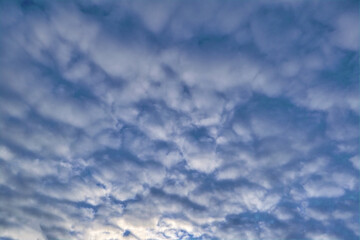 Blue summer sky with white cumulus clouds. Blue sky with clouds nature background.