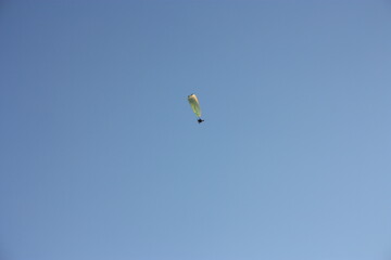 skydiver soars high in the clear sky