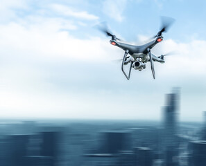 A modern drone in the sky over a large city. Motion effect.