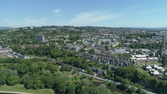 Green hilly vista of Exeter, Devon. College building and church stand out as landmarks