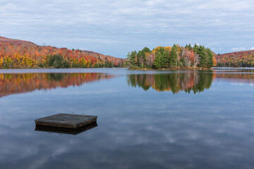 Fototapeta na wymiar Cherry Pond in the Mont Orford National Park at the autumn colors, Quebec, Canada.