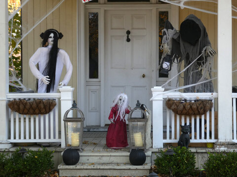 Scary figures near house door  as a Halloween decoration