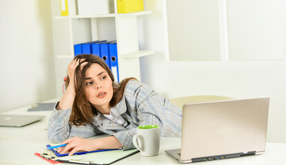 Technology always helps her at work. stylish woman work on notebook. girl follow dress code. tired...