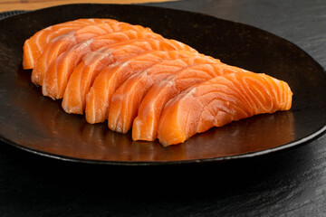 Slices of Raw Salmon Fillet on Black Background Mockup Top View