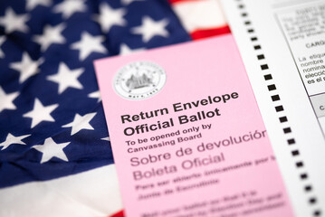 Vote-By-Mail Ballot Envelope Laying on American Flag