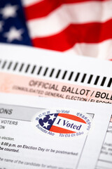 Official Ballot and Voting Instructions with I Voted Sticker Laying on American Flag