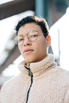 Confident Asian man in fleece jacket on street