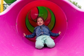 boy jumping tube slide