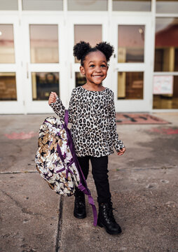 Little girl walking with backpack to school