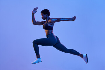 Powerful black athlete leaping during workout