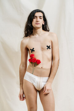 Sexy androgynous model with flowers in tights