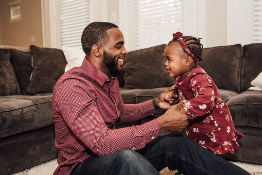 Father and daughter paying and smiling