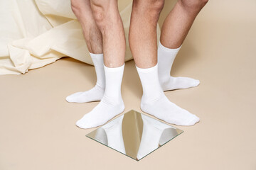 Crop men in socks near mirror